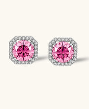 Pink moissanite studs in octagonal sterling silver halo settings with sparkling accent stones on cream background.