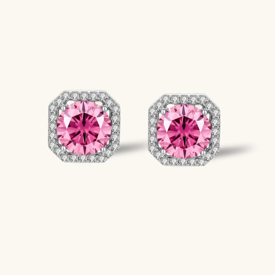 Pink moissanite studs in octagonal sterling silver halo settings with sparkling accent stones on cream background.